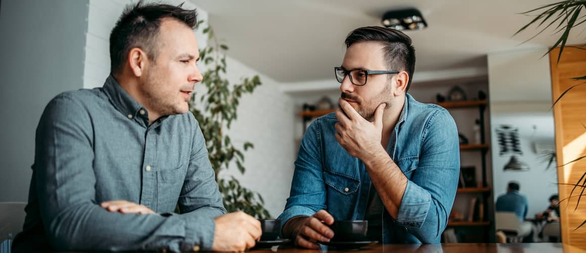 Two coworkers discussing meeting.