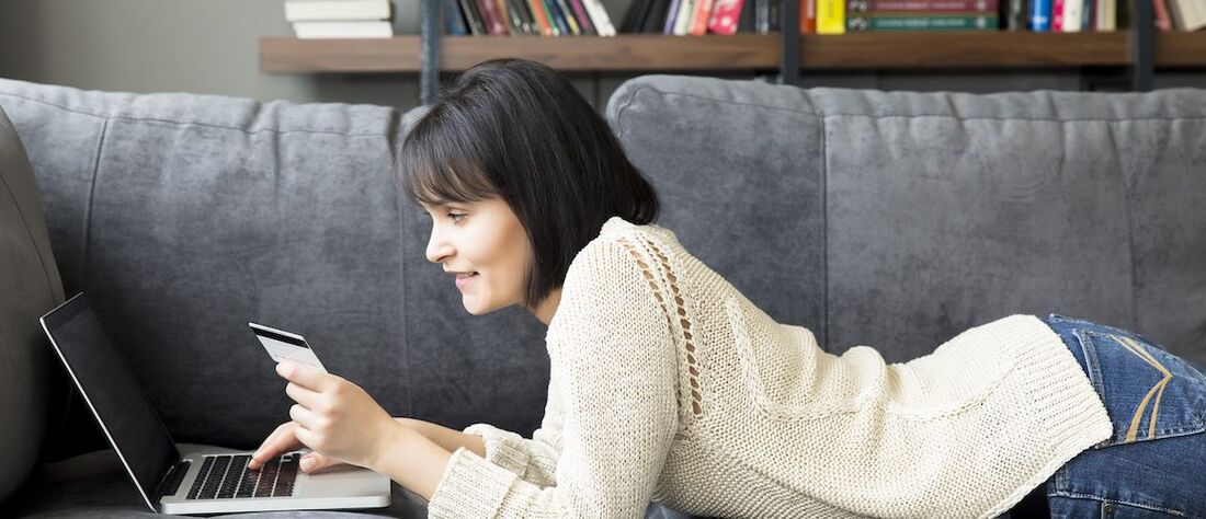 Stock-Woman-With-Credit-Card-On-Couch.jpeg