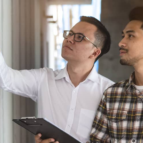 Two men inspecting a house, potentially related to home inspection or real estate assessment.