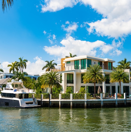 Florida home on the water with boat in front.