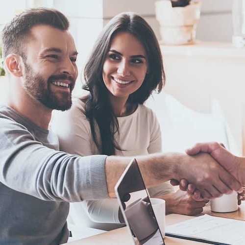 Businessman Shaking Hands Across Table With Client
