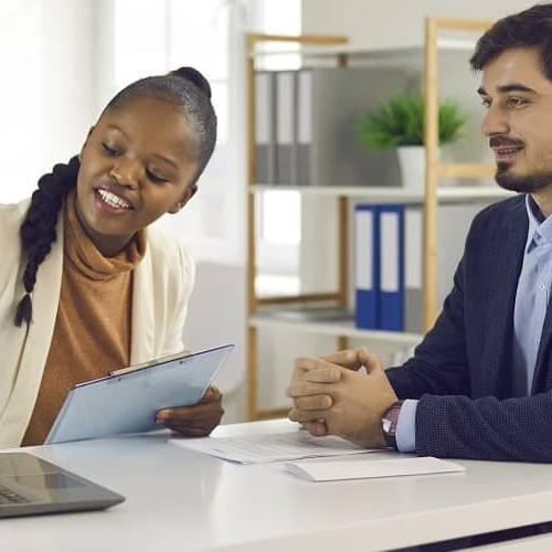 Individuals at a bank discussing a loan or financial matter.