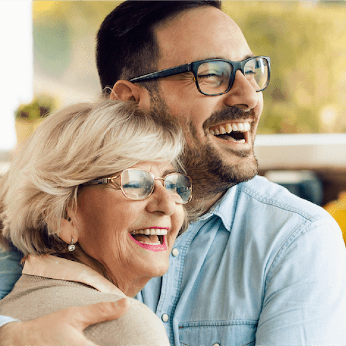 A man and women embracing each other with a smile.