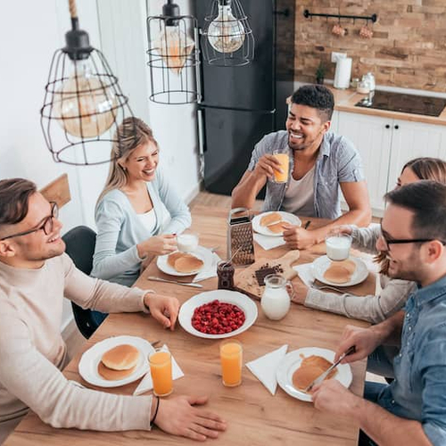 Roommates having breakfast together, indicating shared living arrangements.