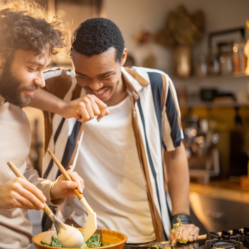 Couple making dinner in kitchen.