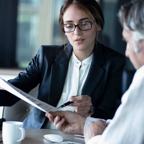 Banker discussing paperwork with a client.