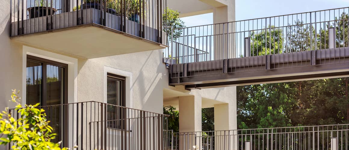 Modern multifamily building featuring balconies on each level.