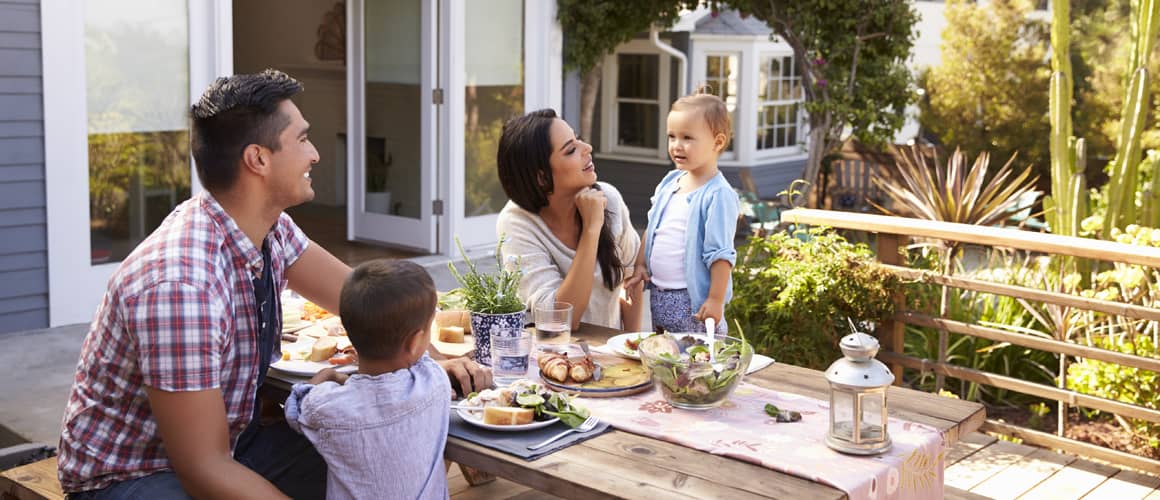 A family having a meal in their backyard.