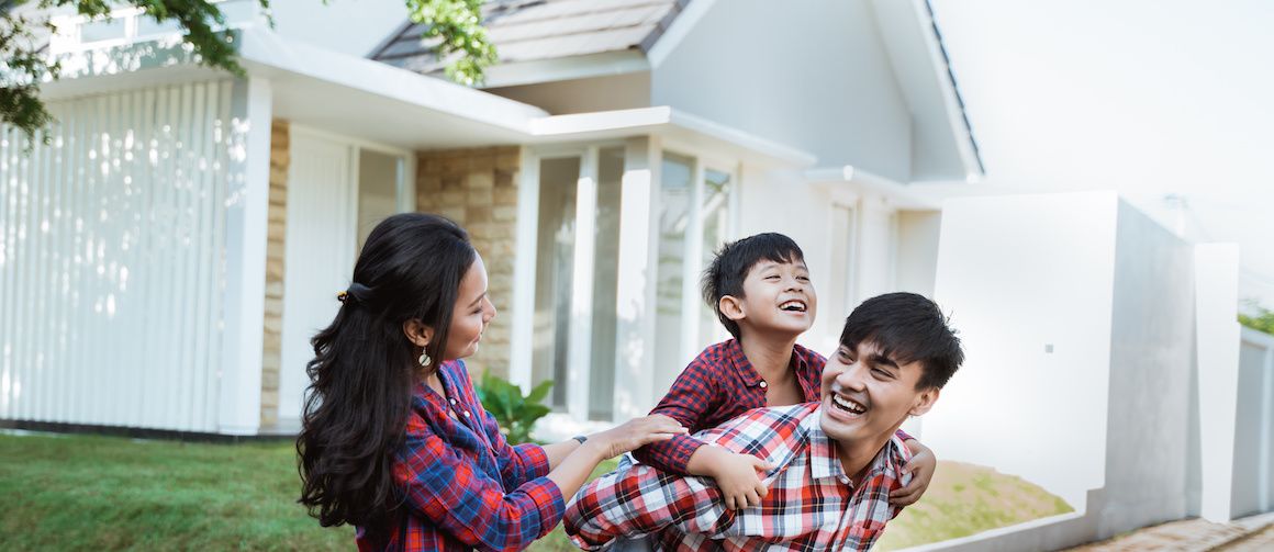 Image of family in front yard enjoying their home.