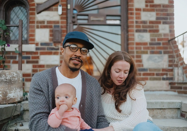 Parents sitting on steps with their baby
