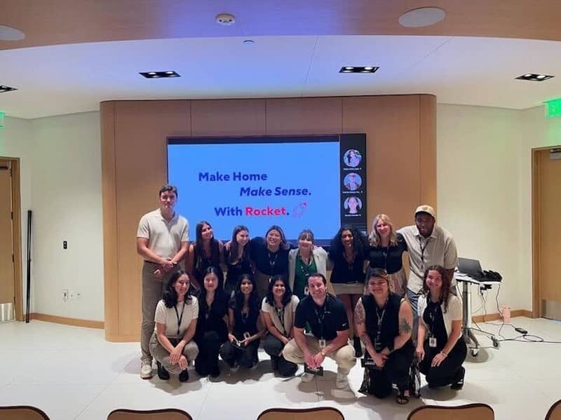 Team members in front of a large screen.
