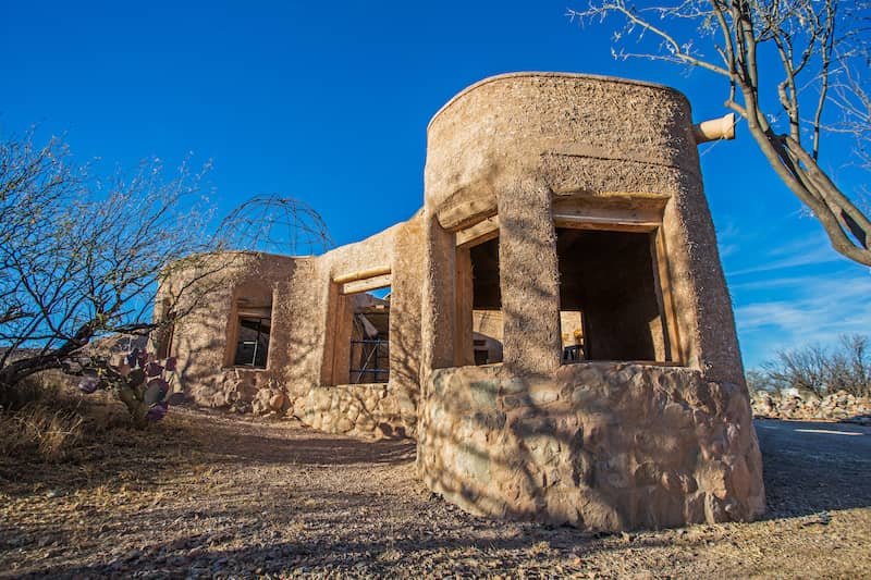 Cob house in the beginning stages of construction.