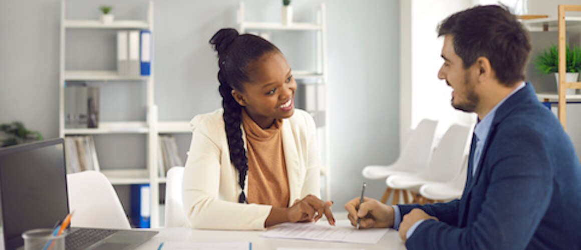 RHB Assets From IGX: African American female lawyer explaining contract details to a Caucasian male client.