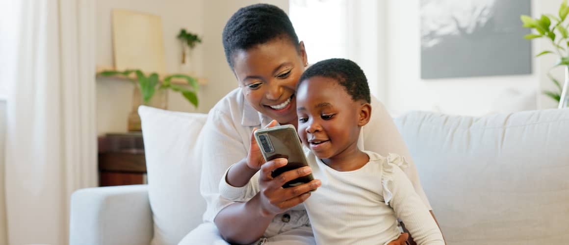 Black family bonding on sofa in living room