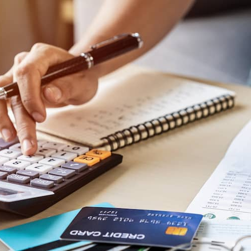 A man calculating debt, potentially involved in financial planning or debt management.