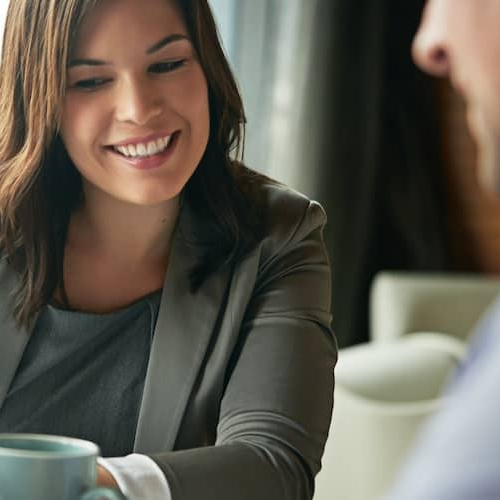 Two people looking over a spreadsheet together.