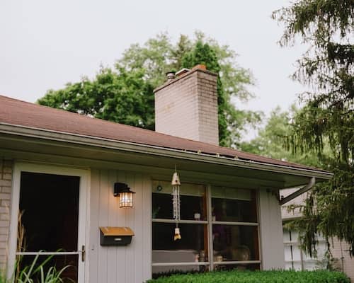 A single family home with light siding and brick.