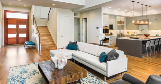 view of a modern open concept living room, entryway and kitchen.