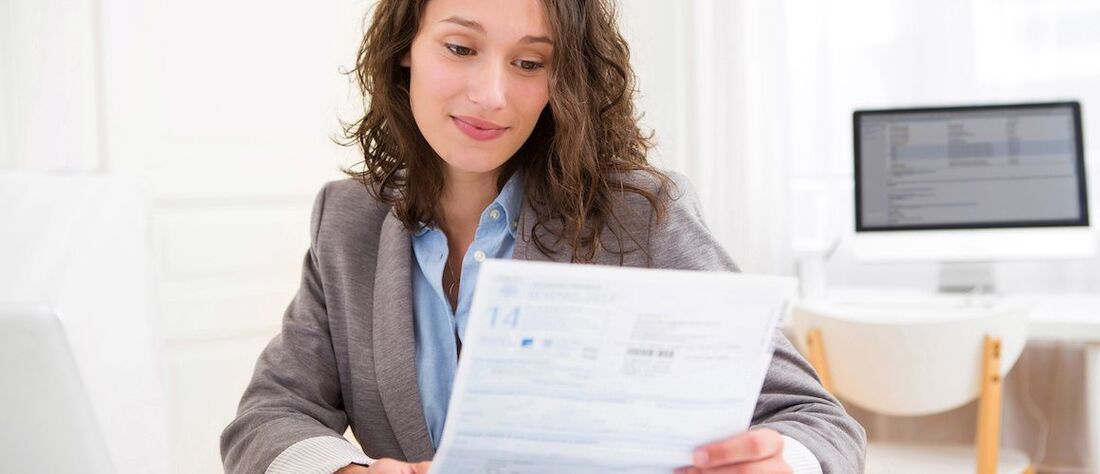 Stock-Woman-Looking-At-Tax-Forms-Adobe-Stock-82675138-copy-compressor.jpeg