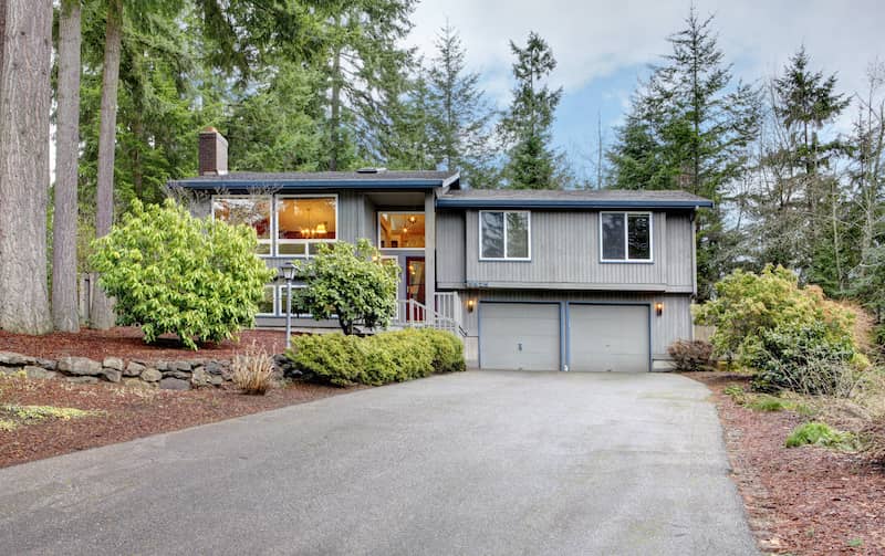 Gray American split level house with two car garage.