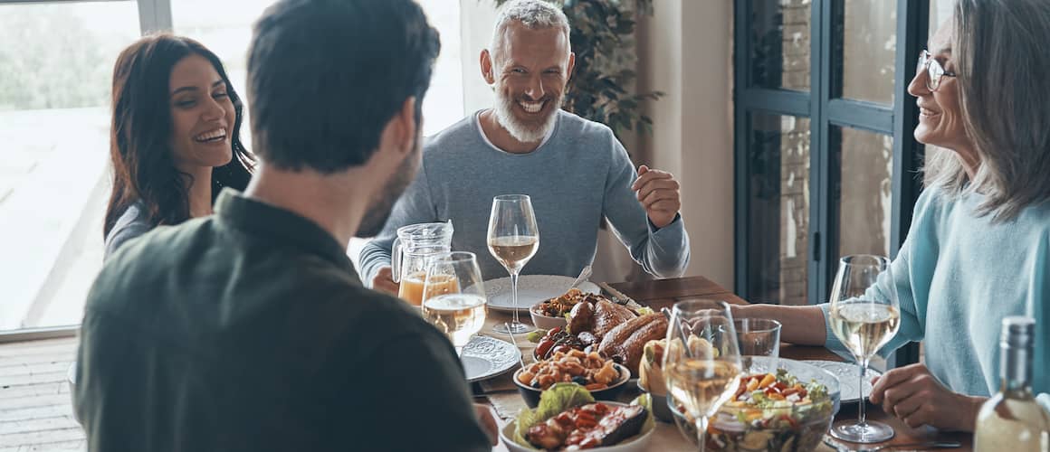 A family enjoying dinner on dining table.