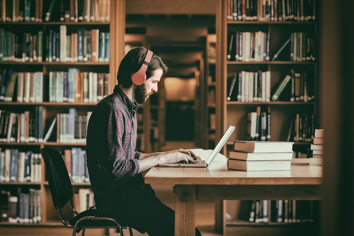 Student inside a library studying 