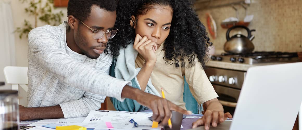 Young couple looking at houses online.