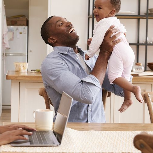 Young couple inside their home with their baby.