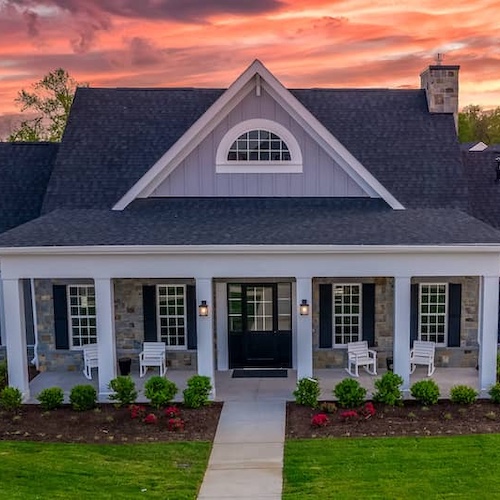 A new multi story home with a blue roof.