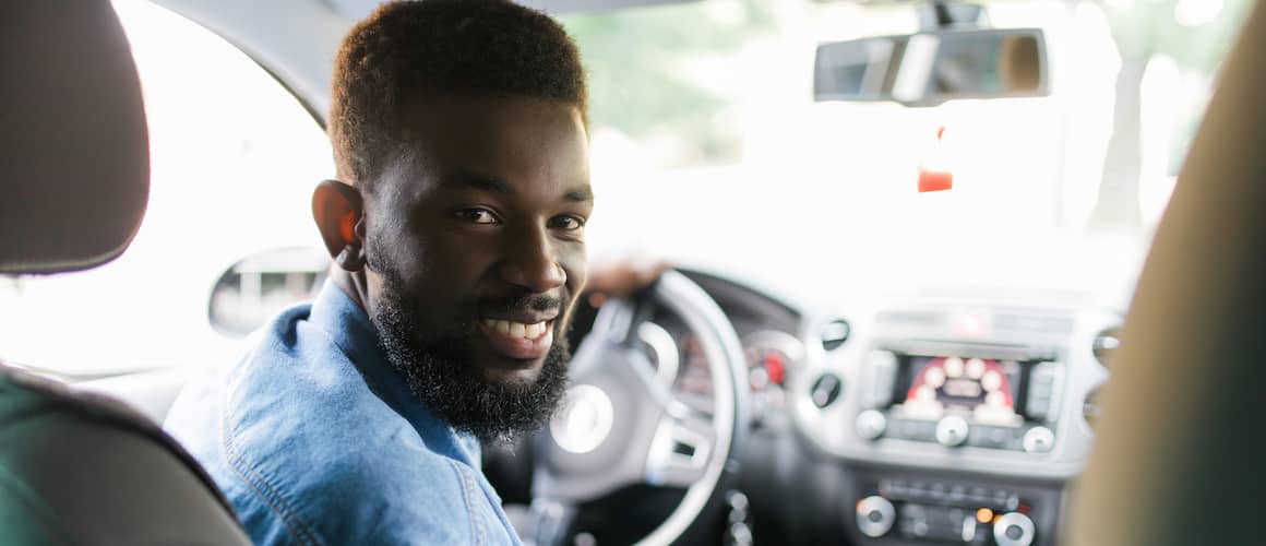 Man buying a car looking back