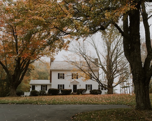 Large colonial home on a gloomy autumn day.
