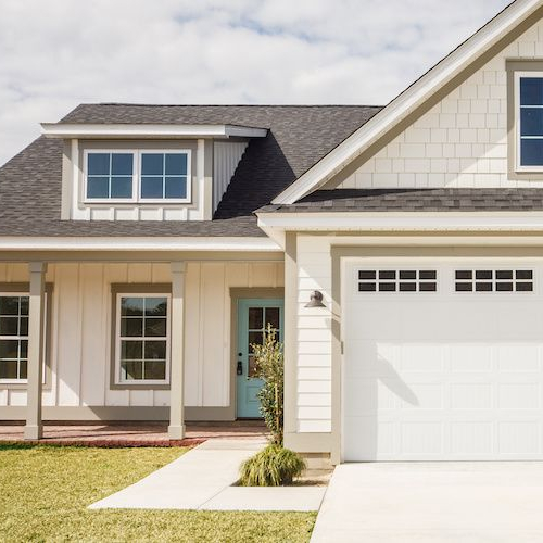 Showcasing a small house with an eye-catching Tiffany blue door.