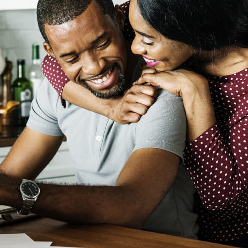 A man and women in kitchen discussing their finances.