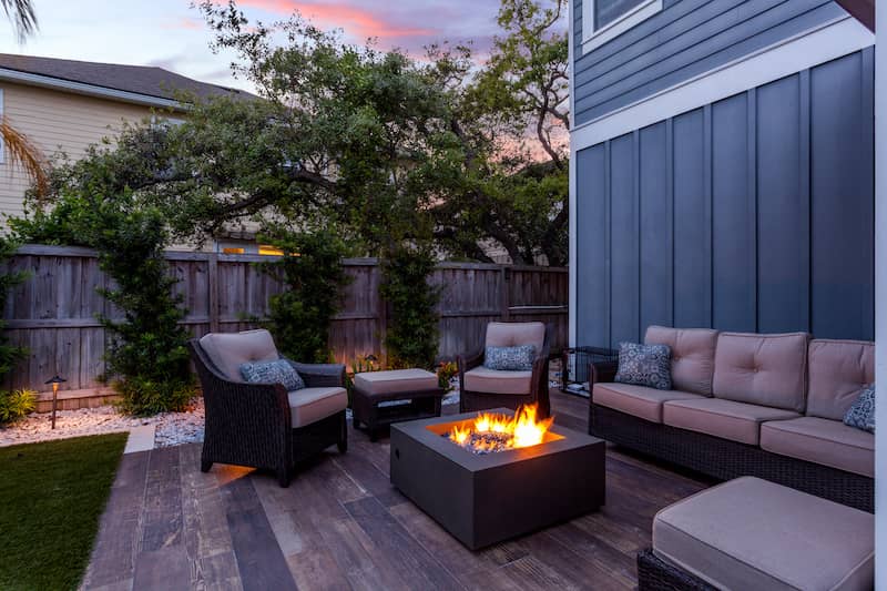 RHB Assets From IGX: Cozy backyard patio with a firepit and seating area.