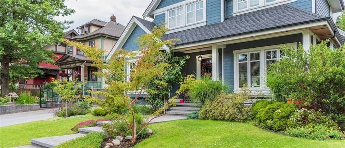 Suburban blue home exterior, displaying a residential property in a suburban setting.