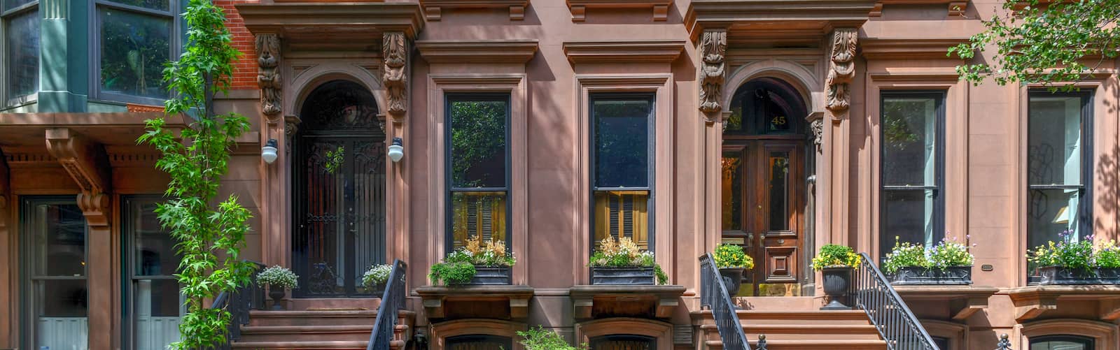 Row of colorful historic brownstone buildings in urban neighborhood 