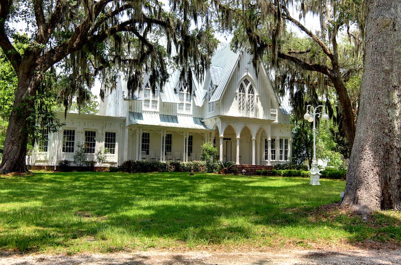 RHB Assets From IGX: Exterior of the Gothic Revival-style Rose Hill Mansion surrounded by greenery.