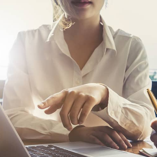 A couple discussing finances, real estate investments or taxes on a laptop.