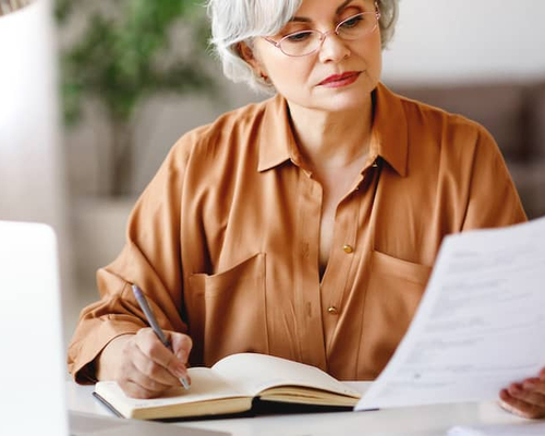 Image of woman reviewing her monthly bills.