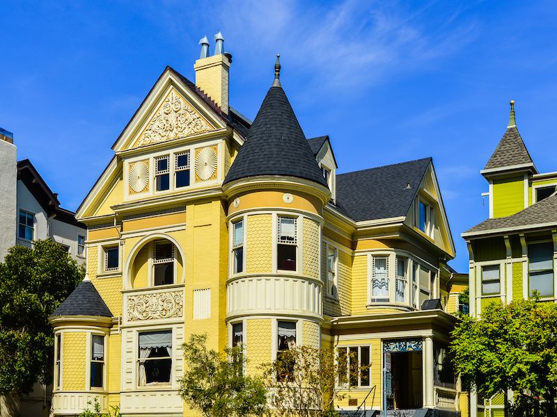 Yellow Queen Anne style Victorian home.