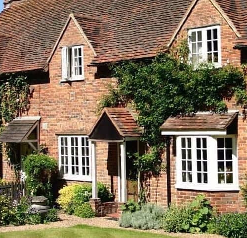 A vintage cottage-style brick home, highlighting its nostalgic and traditional appearance.