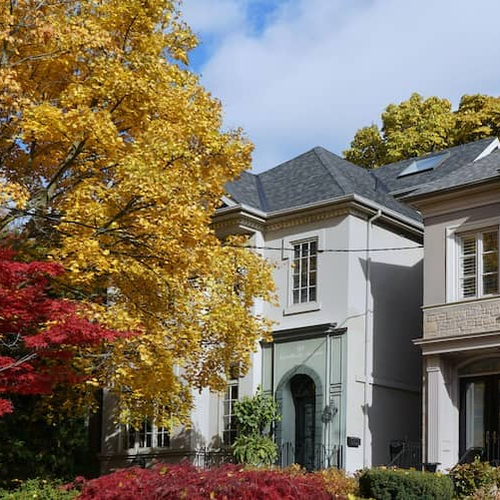Homes in fall, portraying residential properties during the autumn season with foliage and trees.