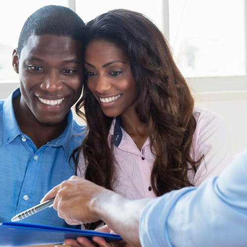 A couple possibly signing the final documents of their new home.