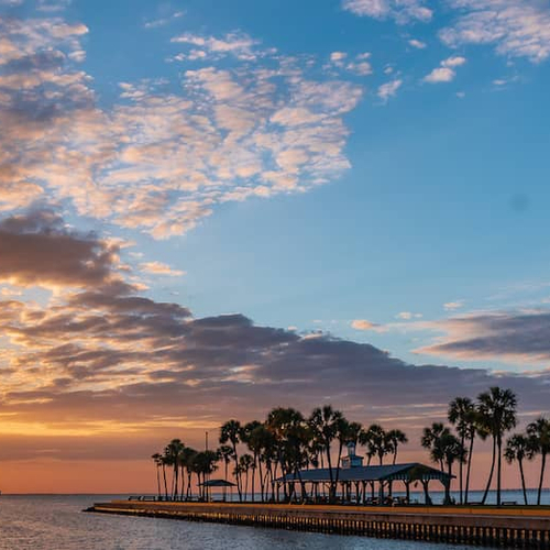 A woman sits comfortaby on a couch