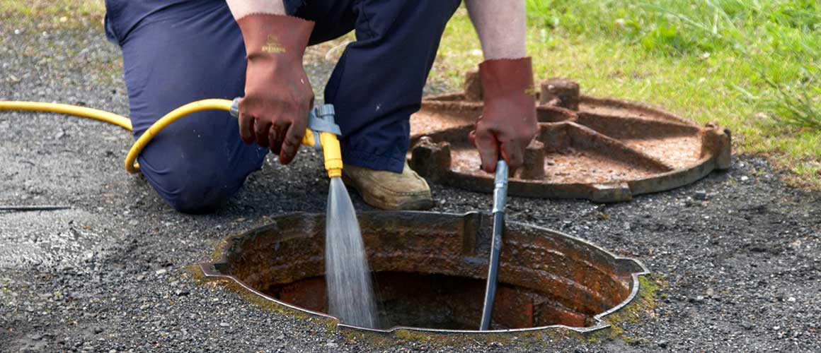 A plumber conducting a sewer inspection or scoping a sewer system.