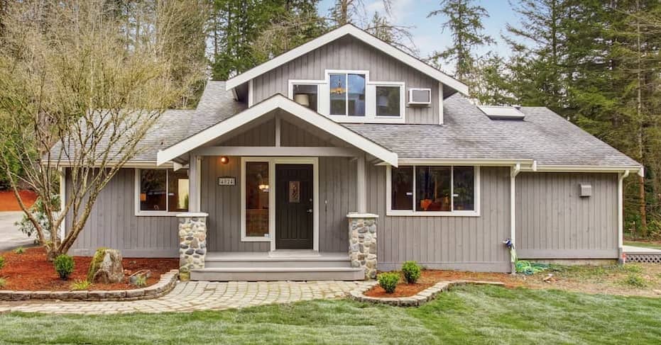 Grey home with white framing and red mulch, depicting a specific house exterior with landscaping.