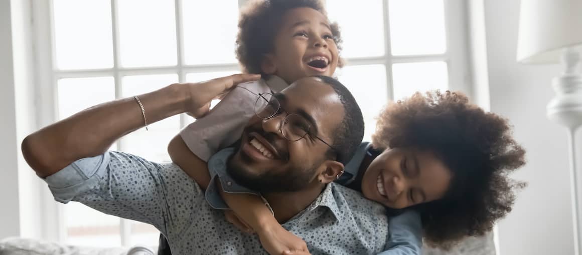 RHB Assets From IGX: A single father with two kids giving piggyback rides.