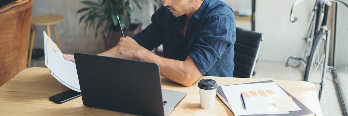 A man calculating his taxes or finances.