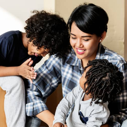 A Black family involved in the process of moving into a new house, indicating relocation or settling.