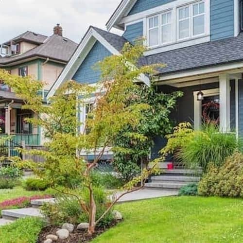 Suburban blue home exterior, displaying a residential property in a suburban setting.